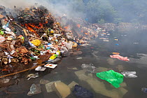 Garbage dump burning, Guanaja Island, Honduras. Caribbean Sea.