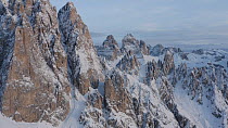 Aerial tracking shot of the Dolomite Mountains in winter, Misurina, Italy, December.