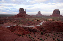 View of the road into Monument Valley with the huge sandstone buttes, 'The Mittens and Merrick butte on the background, Monument Valley, Arizona, USA.