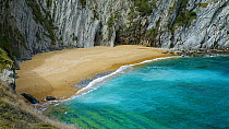 Pan up of Covachos Beach on Castro Island, Municipality of Pielagos, Cantabria, Spain, March.