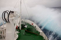Waves crashing over the bow of the Polar Pioneer Cruise Ship crossing the Drake Passage, Antarctic Peninsula, Antarctica.