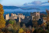 Ludlow Castle, a partially ruined Medieval fortication, with mist over surrounding hills  Ludlow, Shropshire, England, UK. November, 2021.