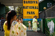 Nepalese tourists posing for 'selfies' outside the gate of Bardia National Park, Terai, Nepal.       Terai