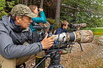 Photographer Tim Laman with daughter, Jessica Laman and son, Russell Laman, filming team for Loon project at work on the shores of Echo Lake, Mount Desert Island. Maine, USA.