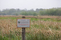 Sign asking dog walkers to keep their dogs on the lead to avoid injury to wildlife in Thorpe Marshes NWT reserve, Norfolk, UK. May.
