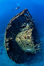 Diver exploring the stern section of the wreck of the Chrisoula K, a cargo ship that struck the reef and sank in August 1981, Abu Nuhas reef, Egypt, Red Sea.