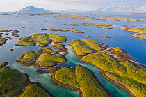 Aerial view of islands and islets far out to sea, in Norway's widest strandflat, Husvaer, Helgeland Archipelago, Norway, Norwegian Sea. July, 2019.
