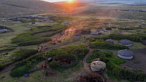 Aerial view of Maasai community bomas / family  homesteads with huts around livestock enclosures, at sunset, east of Ngorongoro Crater, Ngorongoro Conservation Area, Tanzania, Africa.