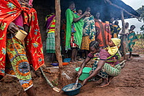 Women with children gathering to eat high nutrition porridge. The porridge is fed to the children to improve their nutritional intake and is specially formulated to provide key nutrients many are lack...