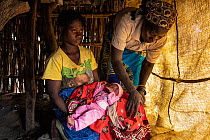 Traditional Birth Assistant advising a new mother about childcare in village of Vinho. Her role is to help assistant women during and immediately after pregnancy, near Gorongosa National Park, Mozambi...