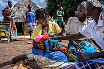 Traditional Birth Assistant advising a mother breastfeeding her baby in village of Vinho. Her role is to help assistant women during and immediately after pregnancy, near Gorongosa National Park, Moza...