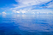 Calm, glassy ocean with clouds on horizon, off the island of Yap, Micronesia, Pacific Ocean.