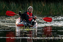 Tracy Lyten, from Skylos Ecology, undertaking kayak training with female Conservation detector dog, in preparation for work to sniff (via kayak) for invasive aquatic weeds; often Common cordgrass (Spa...