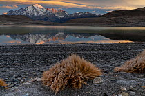 Sunrise over granite peaks of Paine Massif reflecting in lake, Torres del Paine National Park, Magallanes, Chile. June, 2022.