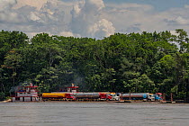 Oil tankers being transported along Napo  river by boat, Orellana, Ecuador, September, 2022.