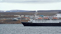 Tourist ship passing by and leaving Pond inlet, Qikiqtaaluk Region, Nunavut, Canada, September.