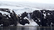 Waterfall and glacier south of Alkefjellet, Spitsbergen, Svalbard, July, 2022.