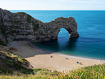 View over Durdle Door, natural limestone arch, and beach.  Lulworth Cove, Dorset, UK. September.