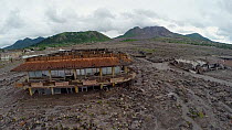 Tracking shot of Plymouth's remains. Plymouth is Montserrat's former capital which was destroyed by the eruption of the Soufriere Hills volcano in 1997. The volcano can be seen in the background. Plym...