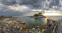 View from a vacation bungalow at Kaya Mawa Lodge looking out over the terrace and Lake Malawi from Likoma Island under stormy sky, Lake Malawi, Malawi, Africa. November, 2017. Stitched image.
