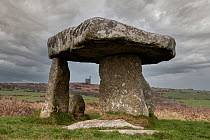 Lanyon Quoit, a Neolithic dolmen / tomb, with the engine house of the Ding Dong mine visible in the background, Madron, near St Just, Cornwall, England, UK. March, 2022.