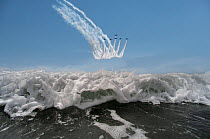 The Red Arrows display team flying in formation over the sea, Rhosneigr, Anglesey, Wales, UK. August, 2022.