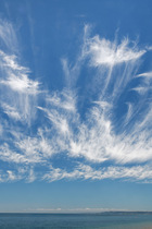 Mare's tail cirrus clouds formed from ice crystals, over the sea, Dorset, English Channel, UK. July.
