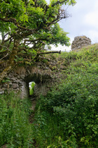 Ruins of 12th century Kenfig Castle, which was engulfed by advancing sand dunes and vegetation in subsequent centuries, Kenfig National Nature Reserve, Glamorgan, Wales, UK. June, 2022.
