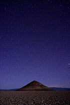 Meteorite over Cono de Arita volcanic cone, Arizaro Salar, Salta, Andes mountains, Argentina, October. Cone reaches 3869 meters.