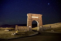 Roosevelt Arch, marking the North Entrance to  Yellowstone National Park, under a starry night sky,  Yellowstone National Park, Montana, USA. September, 2021.