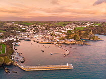Aerial view of Mevagissey village and fishing harbour at dawn, Cornwall, England, UK. January, 2022.