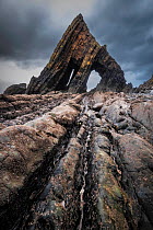Blackchurch Rock, a natural arch stack, under stormy sky, Mountmill, Devon, England, UK. January, 2022.