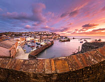 View over Mevagissey fishing harbour at dawn, Cornwall, England, UK. January, 2022.