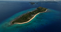 Aerial shot of Dravuni Island. This is Fiji's fourth largest island and is located north of Kadavu, Fiji.