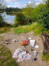 Rubbish left behind by visitors on the shores of Lake Windermere, Ambleside, Lake District, UK. August.