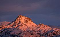 Landscape of mountain range at sunset, with Trevenque peak in centre, during winter.  Sierra Nevada National Park, Andalusia, Spain. February.