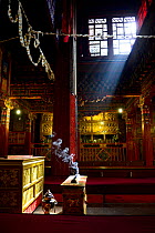 Incense smoke in one of large ceremonial halls in Drepung Monastery, founded in 1416, one of largest Tibetan Buddhist monasteries, Tibet, China.