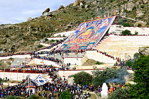 Hundreds of pilgrims flocking to Shotoon Religious Festival, and big thangka, which is held every summer on Drepung Monastery, founded in 1416, one of largest Tibetan Buddhist monasteries, Tibet, Chin...