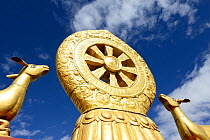 Golden deer and Dharma wheel on roof of Jokhang Monastery, founded between 639 and 647 AD, one of most revered religious structures in Tibet.  Lhasa, Tibet, China.