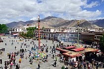 View of Barkhor Square, with hundreds of tourists and pilgrims amidst smoke of incense.  Lhasa, Tibet, China.