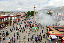 View of Barkhor Square, with hundreds of tourists and pilgrims amidst smoke of incense. Lhasa, Tibet, China.