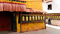 Jam Khang Temple, in centre of Barkhor, with many prayer wheels.  Lhasa, Tibet, China.