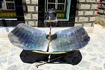 Solar cooker in courtyard of Tranduk Monastery, one of earliest Buddhist monasteries in Tibet from 7th century. Yarlung Valley, Tibet, China.