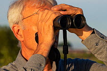 Wouter Helmer, founder of the Dutch river system rewilding efforts since 1995, looking through binoculars. He is also the founder of the ARK foundation, the FREE foundation and one of the founders of...