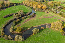 Aerial view of the meanders of the old Oise river, with the new, straight Canal Lateral a l'Oise behind, west of Varesnes, Hauts-de-France, France. October, 2022.