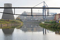 View of old and new industrial buildings, steel mills, gas plants and hydrogen gas plants, along the polluted Sambre river, Charleroi, Belgium. October, 2022.