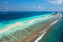 Aerial view along reef and sandbank to Dhigurah island, South Ari Atoll, Maldives, Indian Ocean. February, 2020.