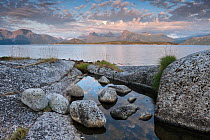 Tidepool at the edge of Tysfjorden with surrounding mountains of Stetind in background, Tysfjord, Nordland, Norway. August, 2012.
