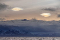 Polar stratospheric clouds and low cloud over snow-covered mountains, Andoya, Norway. December, 2019.