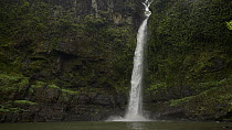 Waterfall at Nandroya Falls falling into lake, Atherton Tablelands, Queensland, Australia.